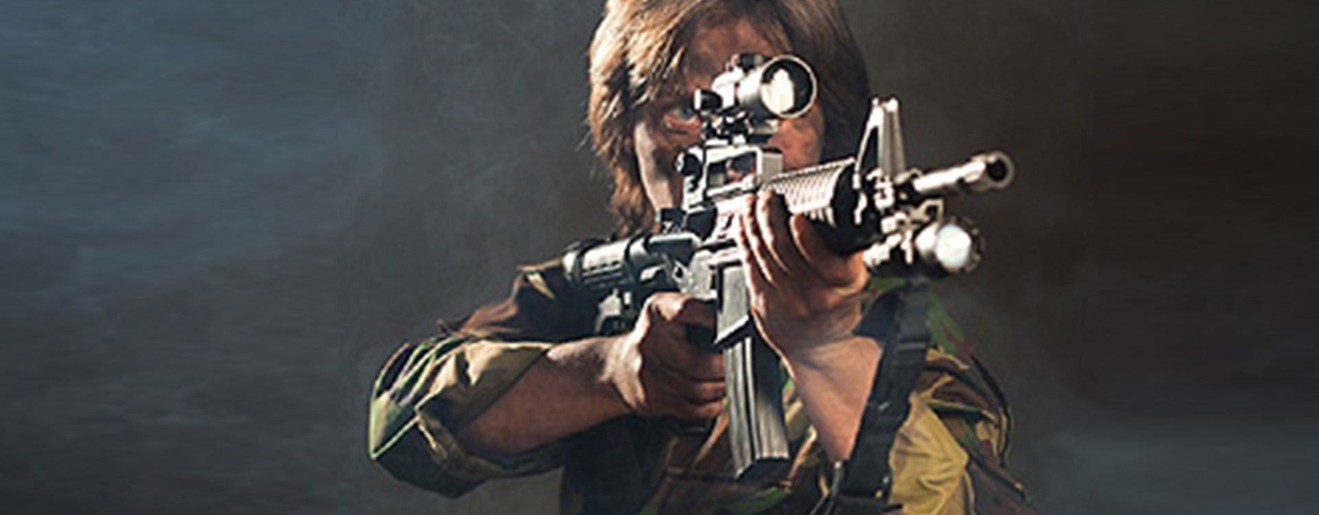 A man with a gun aiming at something in the air.